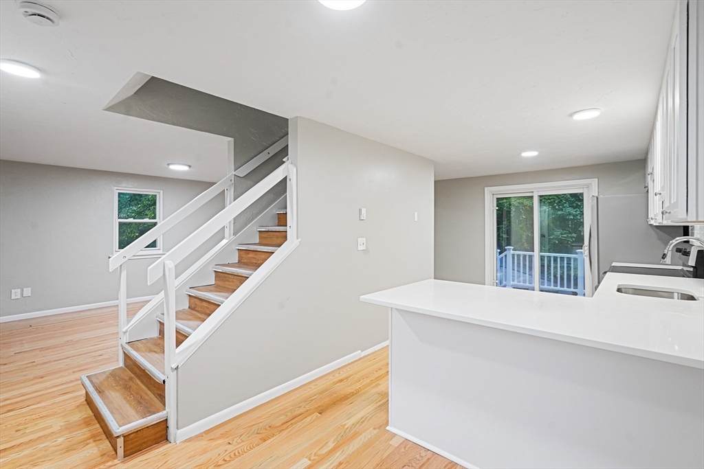 5-9 Debra Lane Bellingham, MA 02019 - Photo 3 of 25 a view of an entryway with wooden floor and staircase