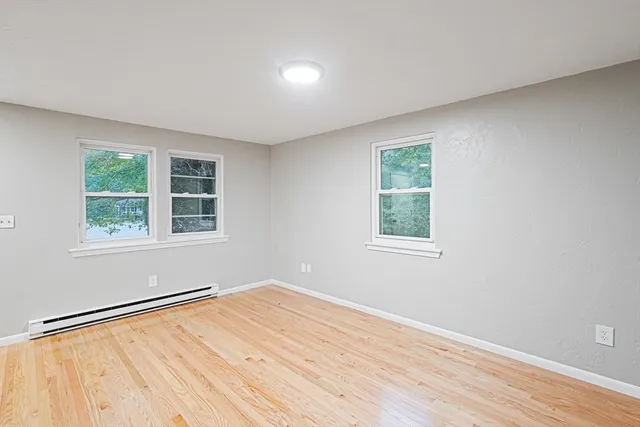 a view of a kitchen with wooden floor and a sink
