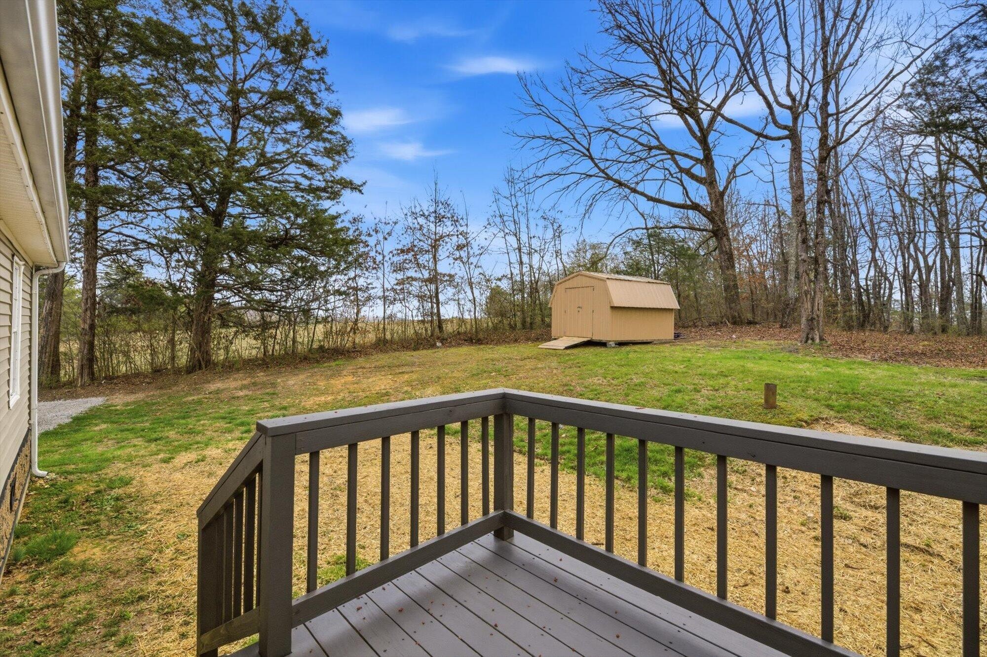 64 County Road 100 Decatur, TN 37322 - Photo 22 of 43 a view of wooden deck and lake with trees in the background