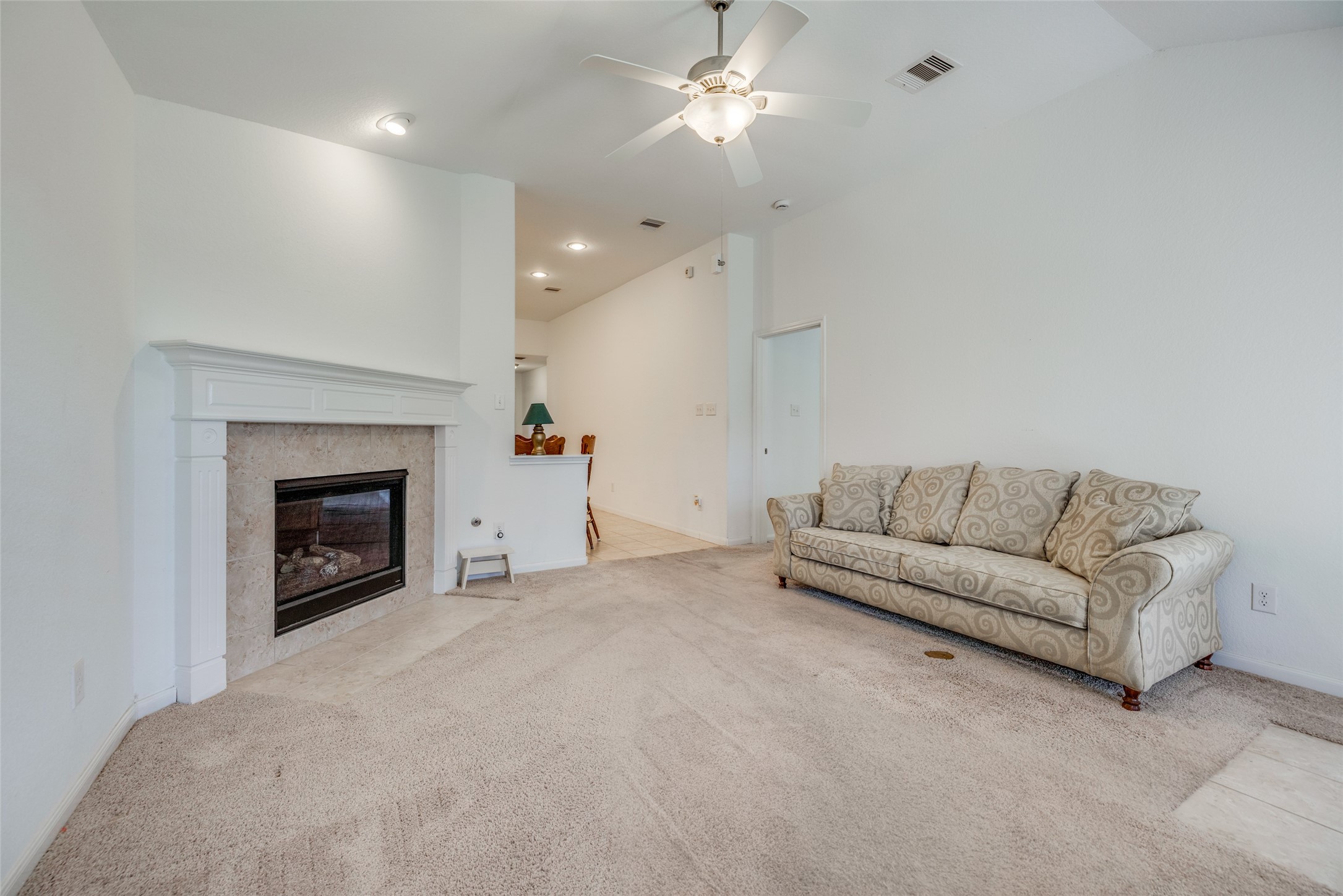 7123 Panther Ridge Drive Spring, TX 77389 - Photo 20 of 31 a living room with furniture a fireplace and a ceiling fan