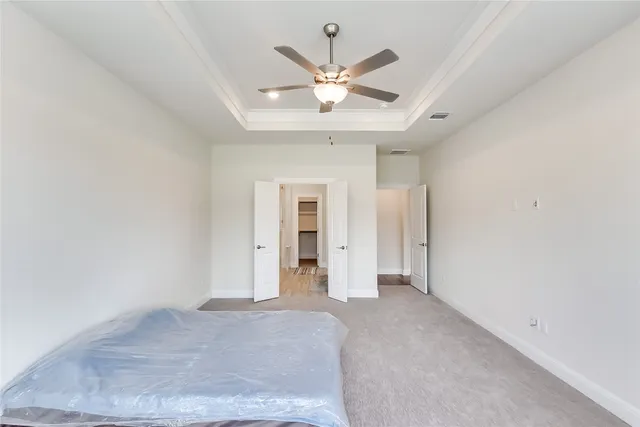 a view of an empty room with a ceiling fan