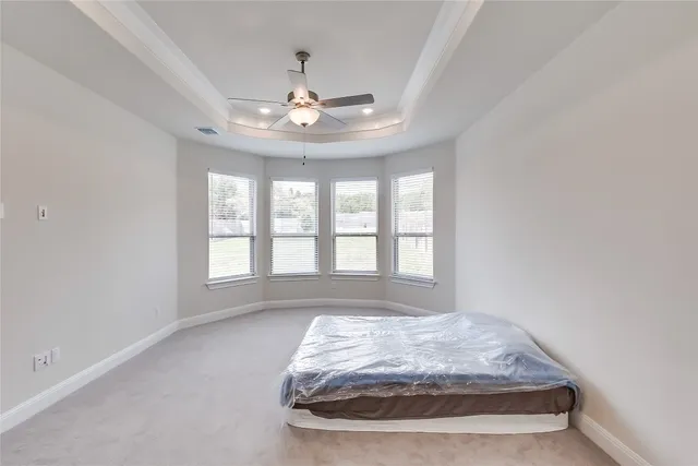 a bedroom with bed and window