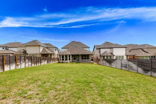 a view of a house with pool and chairs