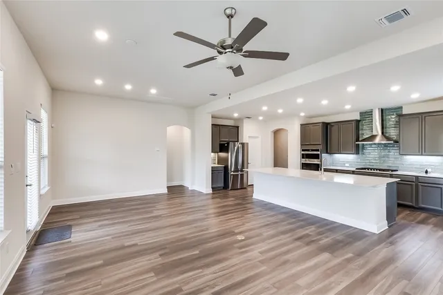 a view of kitchen with cabinets stove and wooden floor
