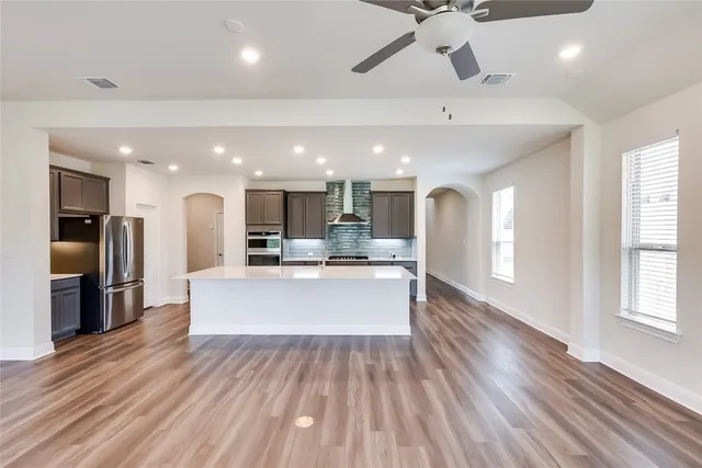 a view of kitchen with refrigerator microwave and wooden floor