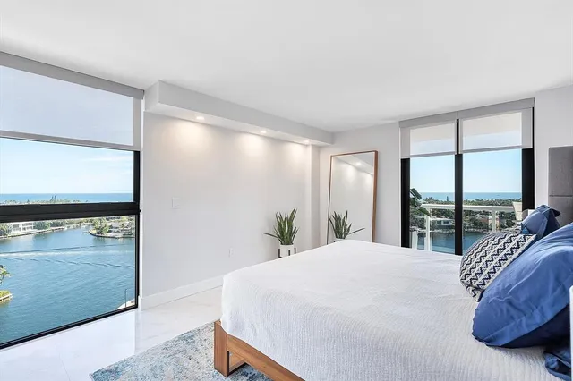 a bedroom with a large bed and a large window