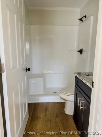 a bathroom with a toilet and a shower