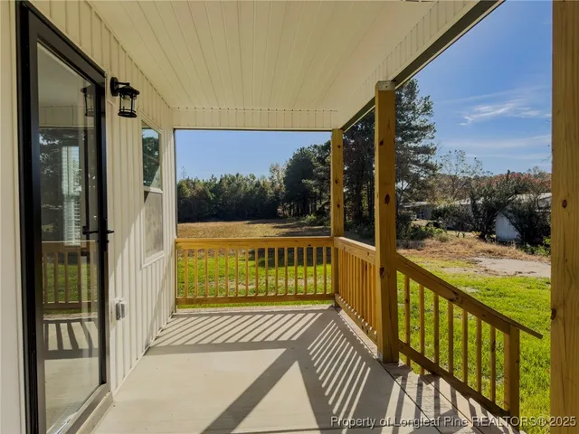 a view of balcony with wooden floor
