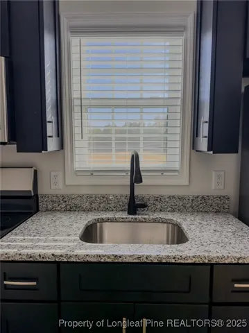 a kitchen with granite countertop a sink and a granite counter tops