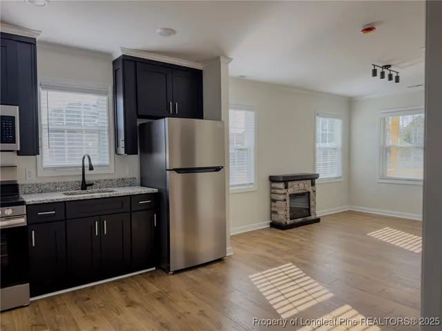 a kitchen with a refrigerator and a sink