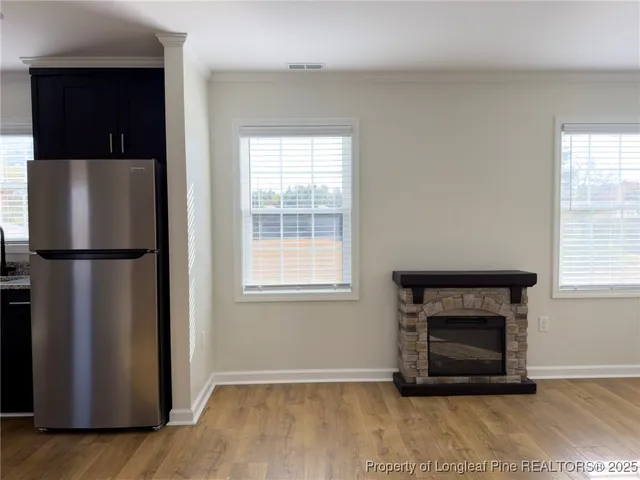 a living room with a fireplace and a window