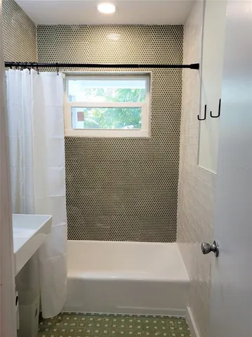 a bathroom with a shower and a tub