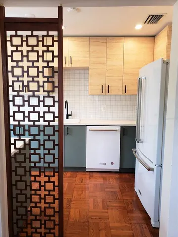 a kitchen with a refrigerator and a sink