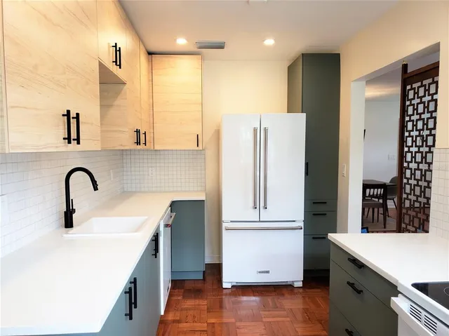 a kitchen with a sink and a refrigerator