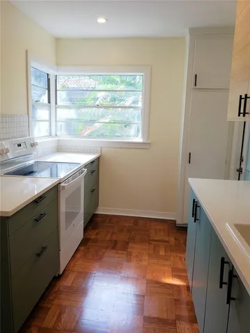 a kitchen with sink and cabinets