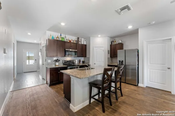 a kitchen with a table and chairs in it