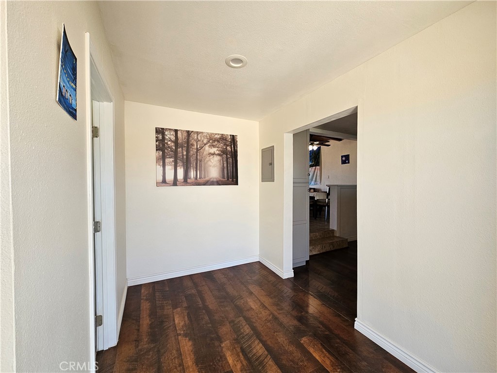 3939 Pinto Mountain Road Twentynine Palms, CA 92277 - Photo 12 of 47 a view of hallway with wooden floor and stairs