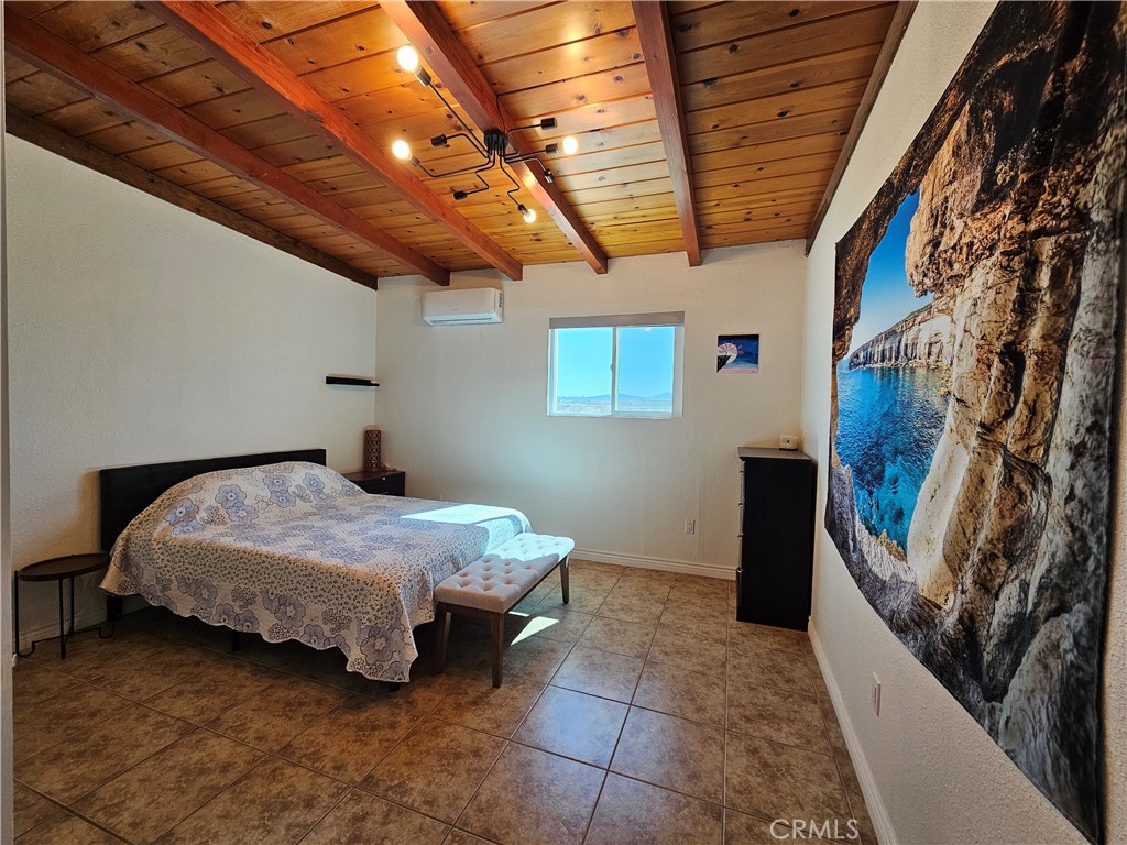 3939 Pinto Mountain Road Twentynine Palms, CA 92277 - Photo 13 of 47 a spacious bedroom with a bed and a dresser