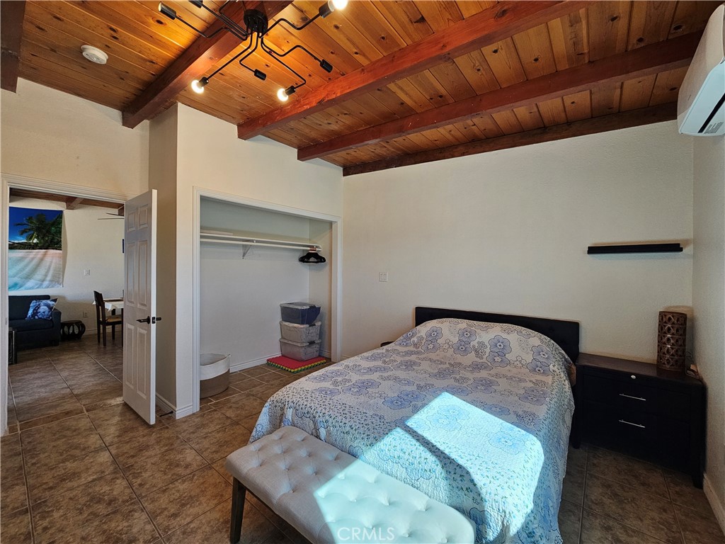 3939 Pinto Mountain Road Twentynine Palms, CA 92277 - Photo 14 of 47 a bed room with a bed and a chair
