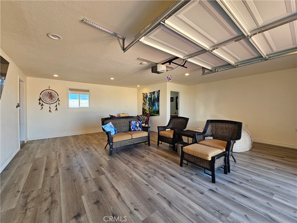 3939 Pinto Mountain Road Twentynine Palms, CA 92277 - Photo 20 of 47 a living room with furniture and a wooden floor