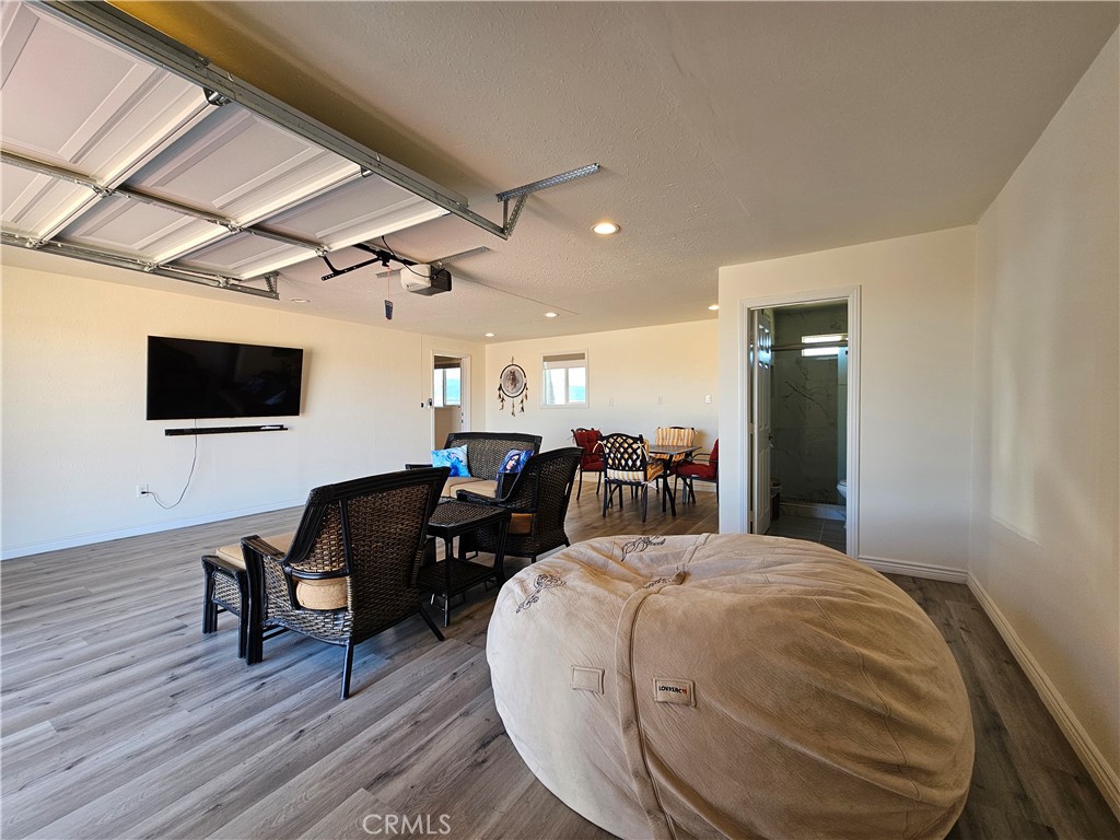 3939 Pinto Mountain Road Twentynine Palms, CA 92277 - Photo 21 of 47 a bed room with furniture and flat screen tv
