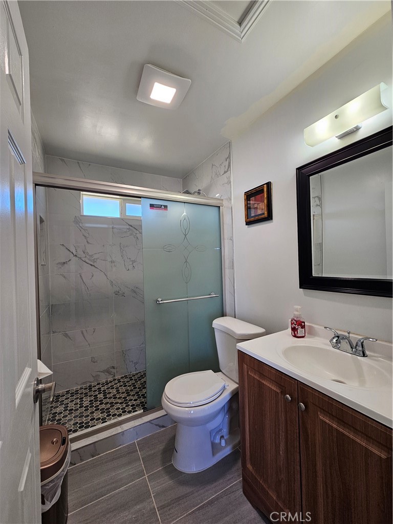 3939 Pinto Mountain Road Twentynine Palms, CA 92277 - Photo 23 of 47 a bathroom with a double vanity sink toilet and a shower