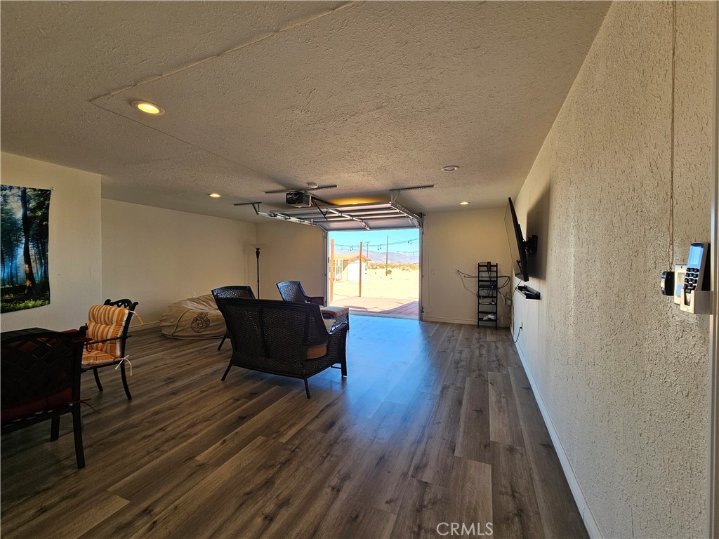 3939 Pinto Mountain Road Twentynine Palms, CA 92277 - Photo 24 of 47 a living room with furniture and a wooden floor