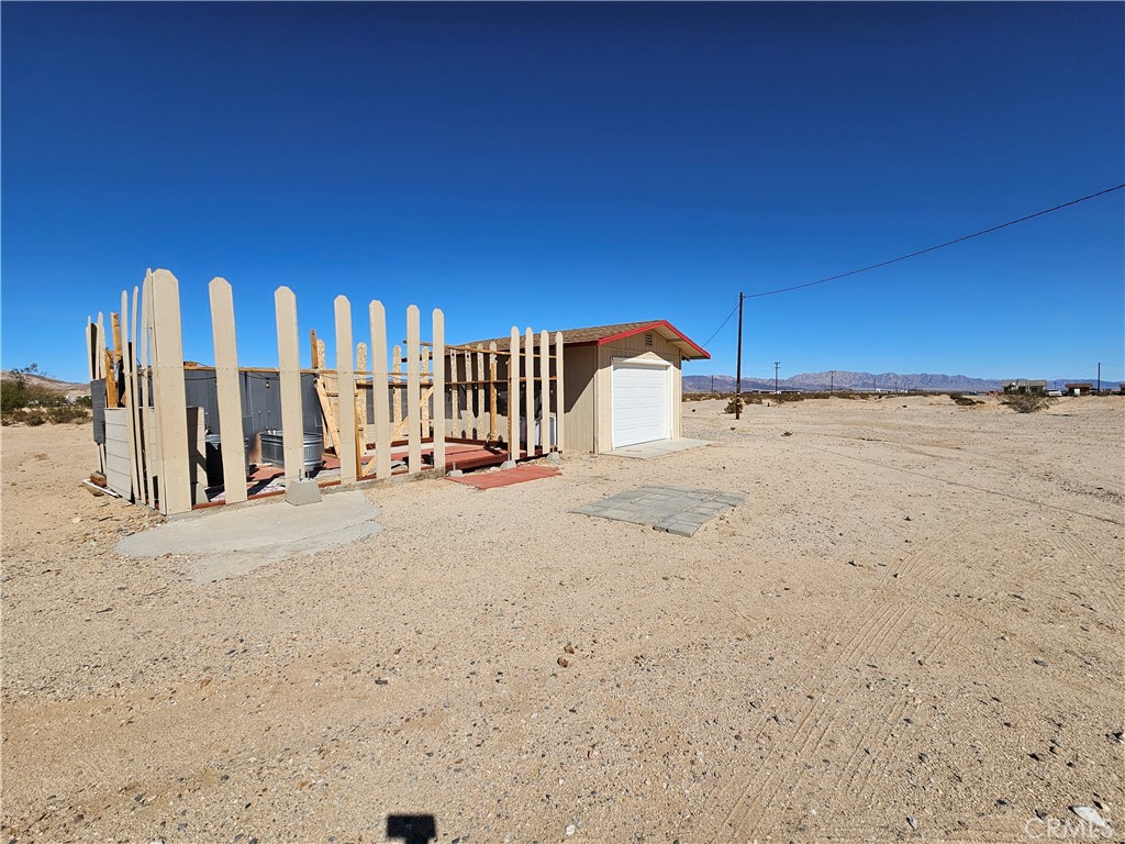 3939 Pinto Mountain Road Twentynine Palms, CA 92277 - Photo 27 of 47 a view of a row of wooden wall in front of a building