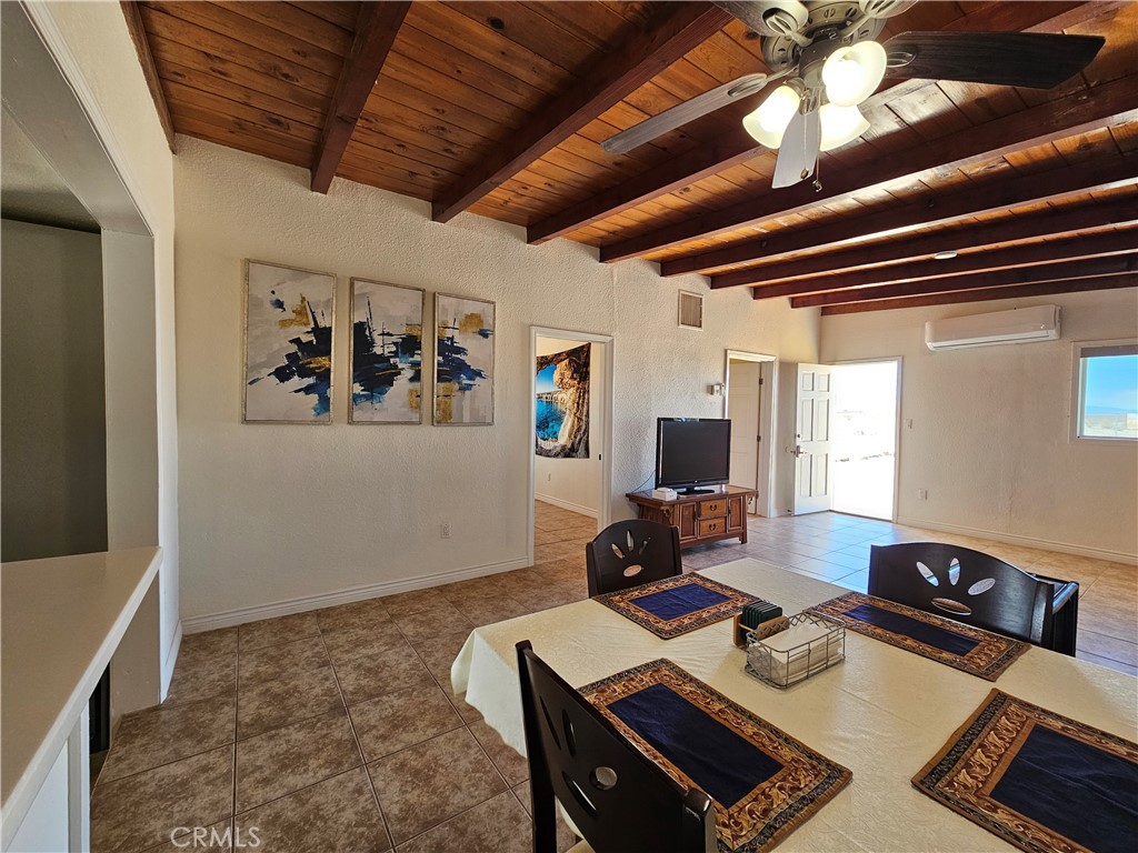 3939 Pinto Mountain Road Twentynine Palms, CA 92277 - Photo 7 of 47 a living room with furniture and a flat screen tv