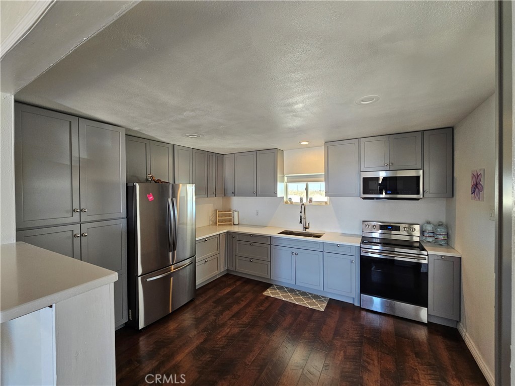 3939 Pinto Mountain Road Twentynine Palms, CA 92277 - Photo 8 of 47 a kitchen with cabinets and stainless steel appliances