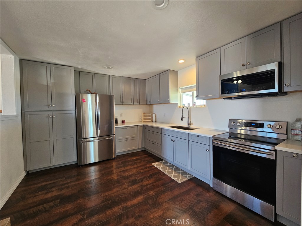 3939 Pinto Mountain Road Twentynine Palms, CA 92277 - Photo 10 of 47 a kitchen with a refrigerator stove and microwave