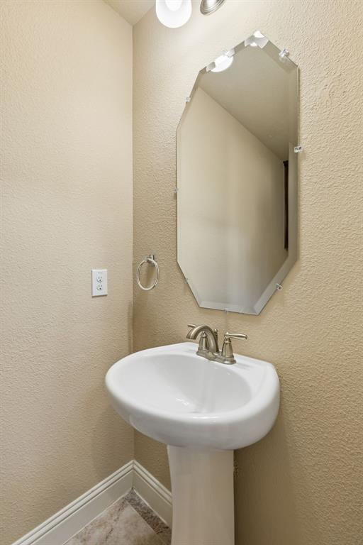537 Hunt Farms Road Fate, TX 75189 - Photo 5 of 36 Pedestal sink with brushed nickel faucet, illuminated by an overhead light fixture