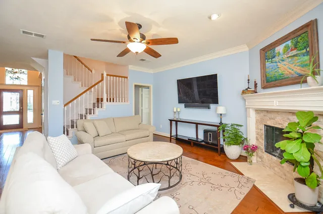 a living room with furniture a fireplace and a flat screen tv