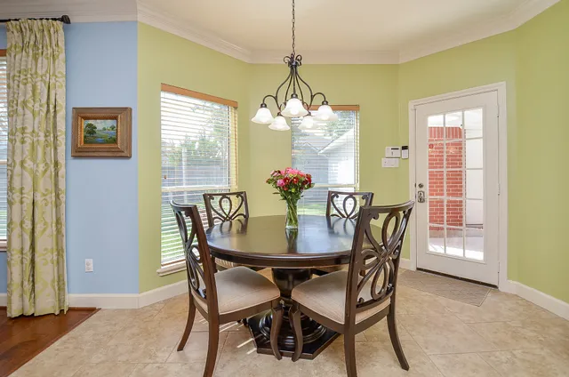 a dining room with furniture and window