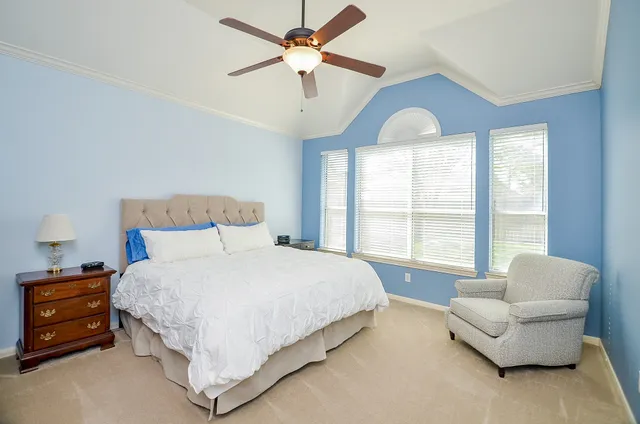 a spacious bedroom with a bed and a couch