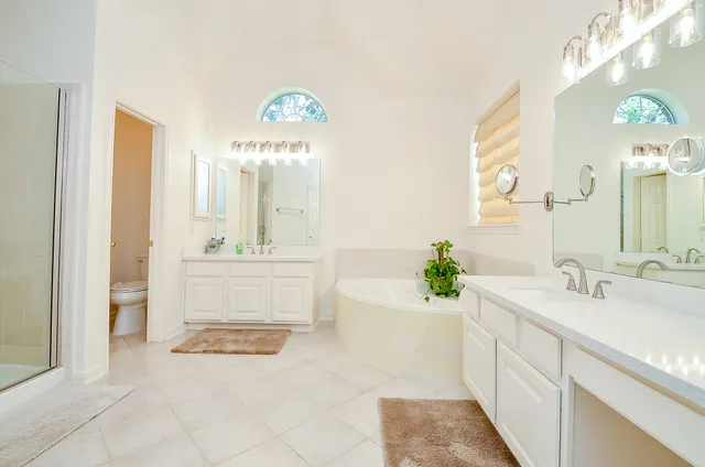 a bathroom with a sink a faucet a mirror and a bathtub