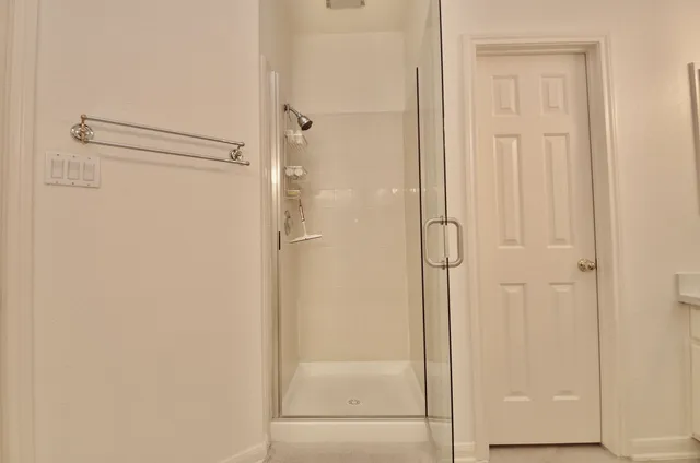 a bathroom with a glass shower door