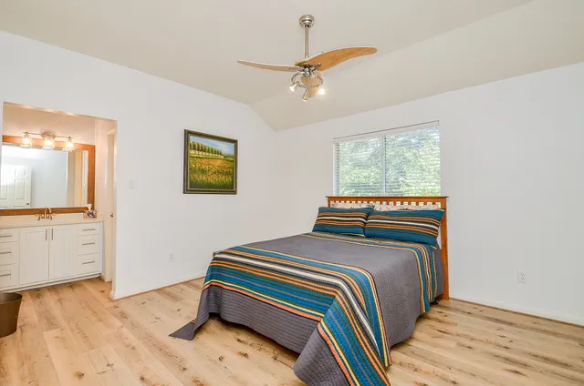 a bedroom with a bed and a chandelier