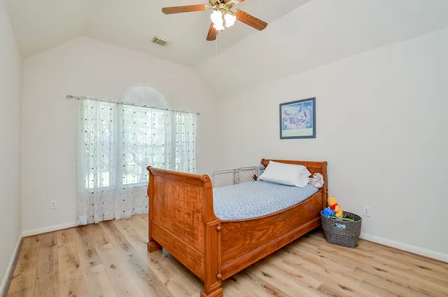 a bed room with a bed and a chandelier
