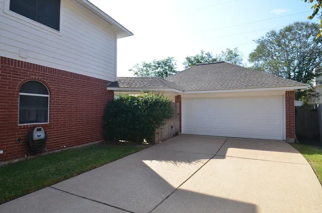a view of a backyard with a garden and swing