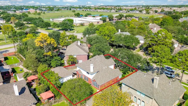 an aerial view of a house with a yard and garden