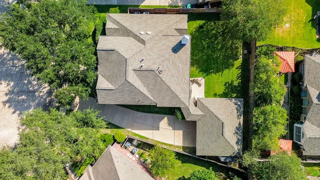 a view of a big yard in front of a brick house