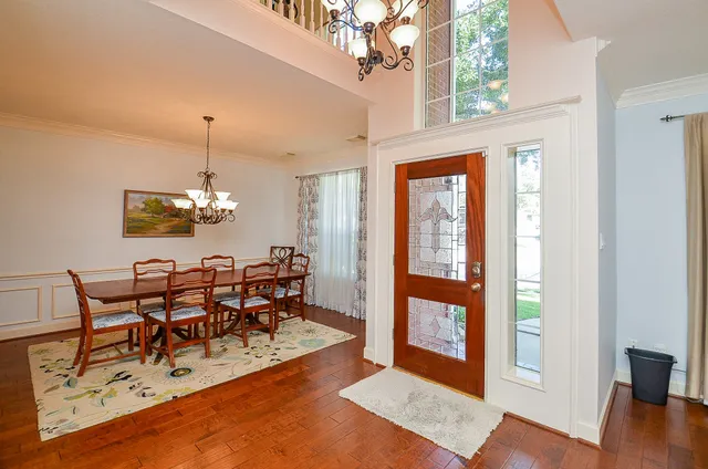 a view of a dining room with furniture wooden floor and chandelier