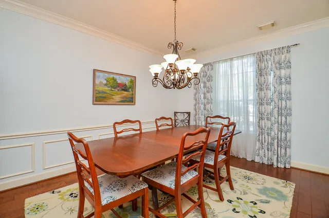 a dining room with furniture and chandelier