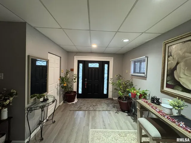 a dining room with furniture a chandelier and wooden floor