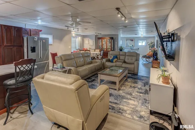 a kitchen with stainless steel appliances kitchen island granite countertop a sink stove and refrigerator