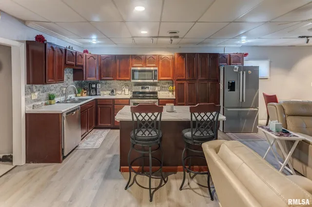 a kitchen with granite countertop a stove sink and cabinets