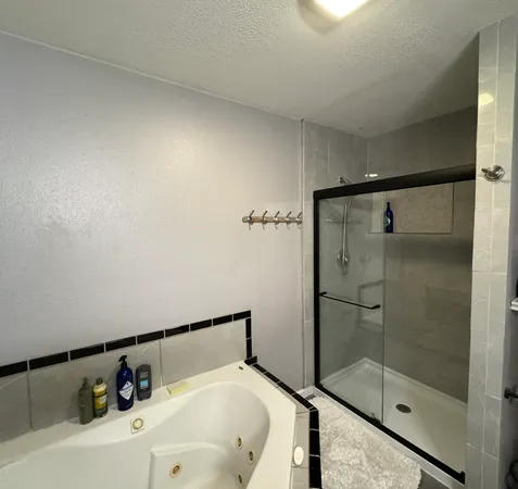 a bathroom with a glass shower door