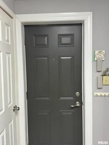 a room with furniture a piano and a bookshelf