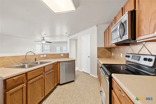 a kitchen that has a sink and a stove